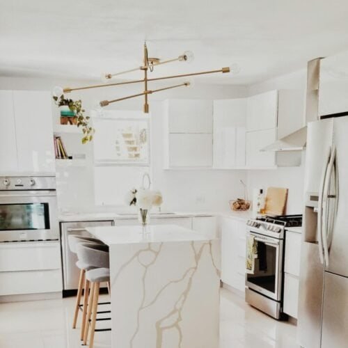 pexels-photo-3718434-3718434 A bright, modern kitchen featuring white cabinetry, stainless steel appliances, and minimalist decor.