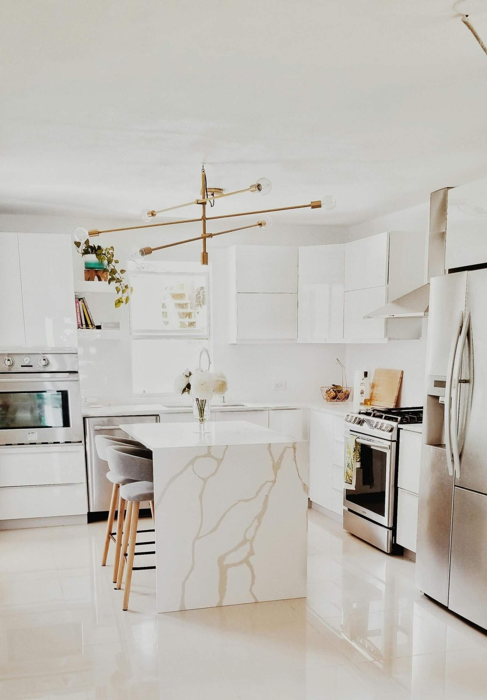pexels-photo-3718434-3718434 A bright, modern kitchen featuring white cabinetry, stainless steel appliances, and minimalist decor.
